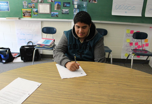 Male student sitting at table