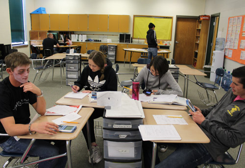 Four students doing classwork