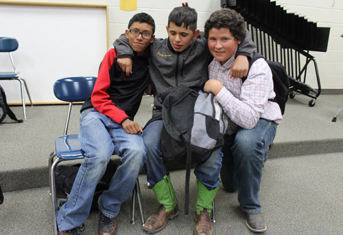 Three students hugging