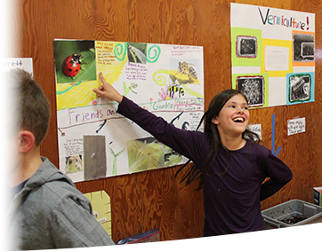 girl pointing at board